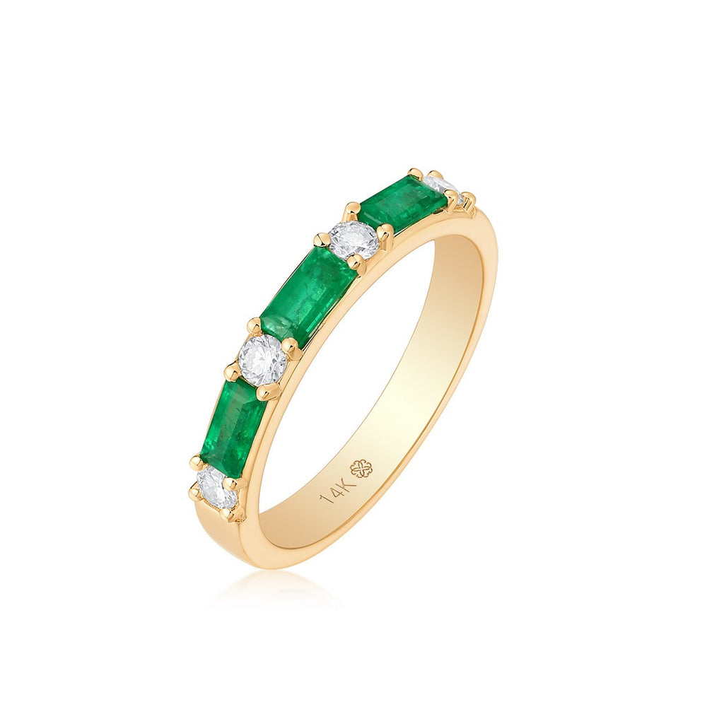 Yellow gold eternity band with alternating emerald and diamond stones - angled view