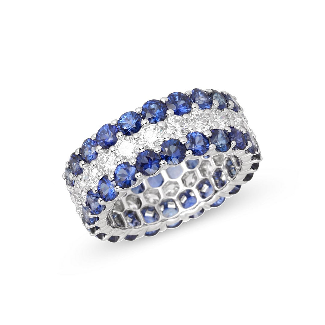 White gold triple-row eternity ring with two rows of round blue sapphires and a center row of white diamonds