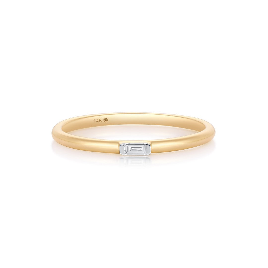 Yellow gold ring with a baguette-cut diamond bar on a white background