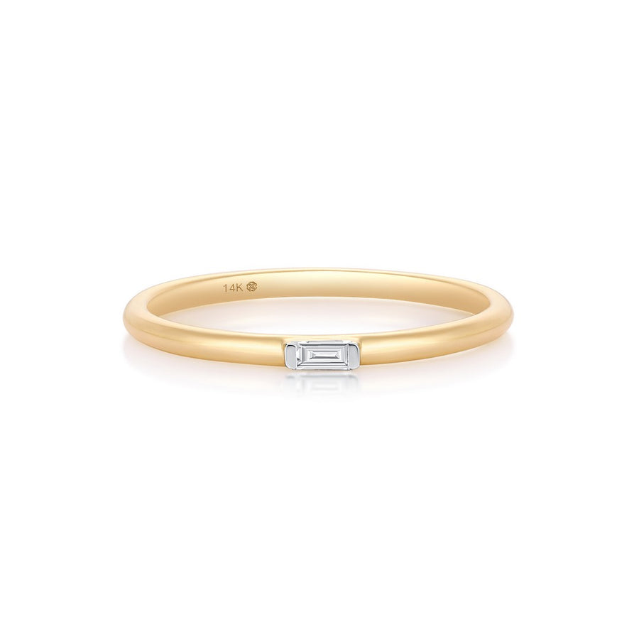Yellow gold ring with a baguette-cut diamond bar on a white background