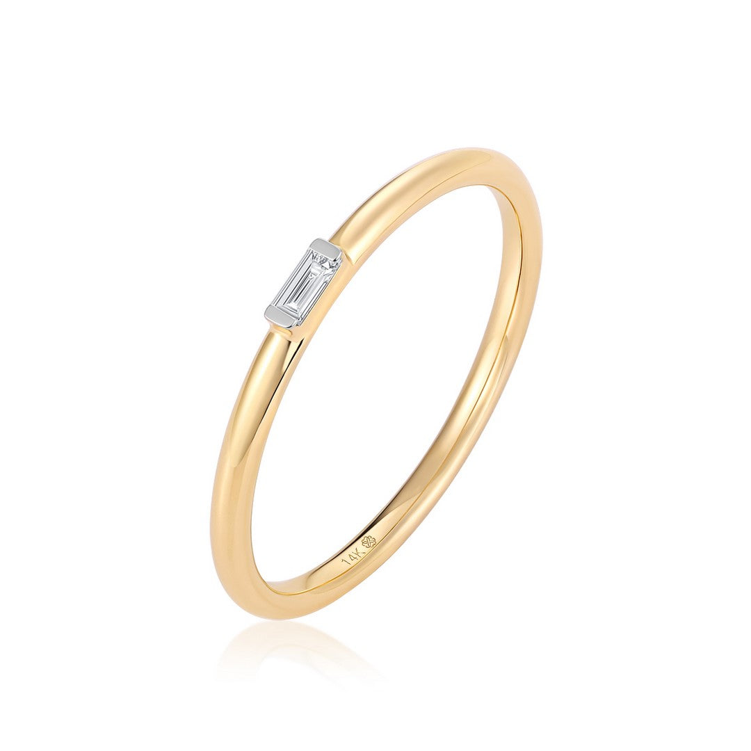 Yellow gold ring with a baguette-cut diamond bar on a white background - angled view