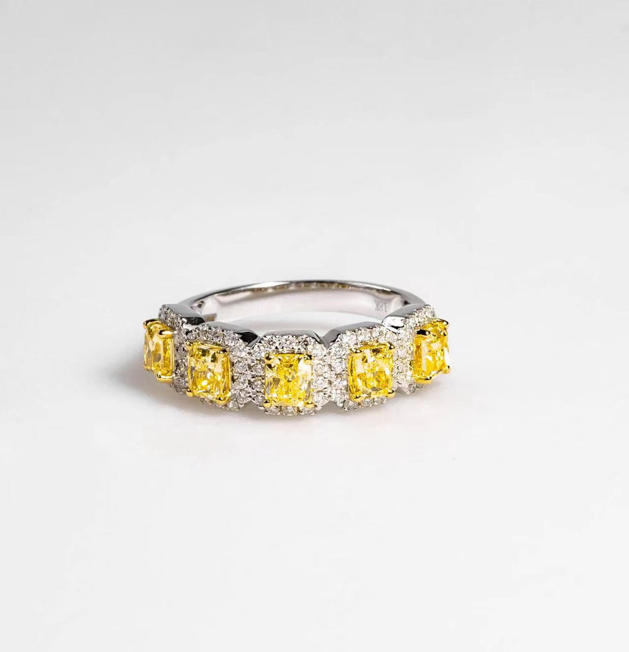 18k white gold eternity ring with rectangular yellow diamonds and white diamond halos on a white background