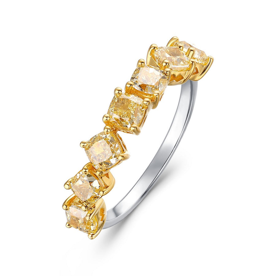 White gold ring with yellow cushion-cut diamonds in yellow gold prong settings on a white background